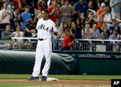 Congressman Cedric Richmond stands on third base after his triple in Congressional baseball game.
