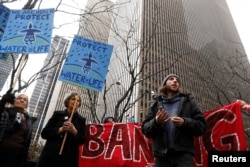 FILE - Demonstrators protest against the Dakota Access Pipeline, outside the Mizuho Bank in New York, Feb. 1, 2017.