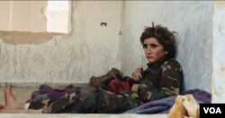 Osama, 13, wears a military uniform in a youth training camp run by former al-Qaida-affiliated group al-Nusra Front. (Kahtan Hasson for VOA)