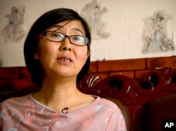 FILE - In this April 18, 2015 file photo, Wang Yu, a lawyer for Chinese activist Li Tingting, speaks during an interview in Beijing.
