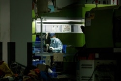 A man works at a manufacturing plant of Universal Electronics Inc. in Qinzhou in Guangxi Autonomous Region, China, April 12, 2021.