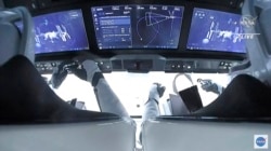 In this image from video made available by NASA, astronauts in the SpaceX Dragon capsule approach the International Space Station, Nov. 11, 2021.