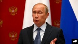 Russian President Vladimir Putin speaks at a joint news conference with Swiss Federal President Didier Burkhalter in Moscow, May 7, 2014..
