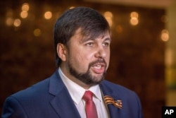 FILE - Denis Pushilin, Donetsk Russian-backed separatist representative, meets with the media after talks in Minsk, Belarus, May 6, 2015.