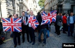 Vote Leave supporters wave Union flags, following the result of the EU referendum, outside Downing Street in London, Britain June 24, 2016.