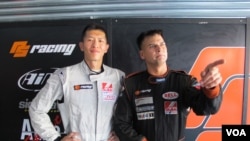 Race car drivers Sunny Wong and Pete Olson promote the charity the Child Fund in Zhuhai, China, Sept. 15, 2013. (Marianne Brown for VOA)