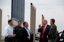 President Donald Trump reviews border wall prototypes, March 13, 2018, in San Diego.