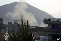 Smoke rises from the site of the second deadly suicide attack on police stations in one day, May 9, 2018, in Kabul, Afghanistan. The Taliban claimed responsibility for the series of attacks.