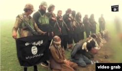 An image from a purported Islamic State group video showing captives.