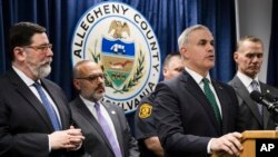 United States Attorney Scott Brady, at podium, speaks with members of the media during a news conference in the aftermath of a deadly shooting at the Tree of Life Synagogue in Pittsburgh, Oct. 28, 2018.