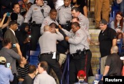 FILE - Police officers forcibly restrain a protester at U.S. Republican presidential candidate Donald Trump's campaign rally in Fayetteville, North Carolina, March 9, 2016.