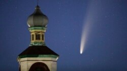 The comet Neowise or C/2020 F3 is seen behind an Orthodox church over the Turets, Belarus, 110 kilometers (69 miles) west of capital Minsk, early Tuesday, July 14, 2020. (AP Photo/Sergei Grits)