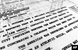 FILE - Part of a file from the CIA, dated Oct. 10, 1963, details "a reliable and sensitive source in Mexico" report of Lee Harvey Oswald's contact with the Soviet Union embassy in Mexico City, that was released for the first time on Nov. 3, 2017.