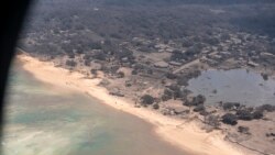 In this photo provided by the New Zealand Defense Force, volcanic ash covers roof tops and vegetation in an area of Tonga, Jan. 17, 2022.