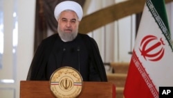 FILE - In this photo released by the office of President Hassan Rouhani addresses the nation, in Tehran, Iran, Oct. 13, 2017. Rouhani spoke after U.S. President Donald Trump accused Iran of violating the spirit of the 2015 nuclear accord.