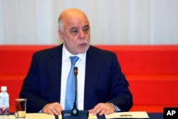 FILE - Iraq's Prime Minister Haider al-Abadi delivers a speech at an economic development conference in Tokyo, April 5, 2018.