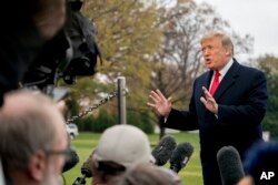 President Donald Trump speaks to members of the media before boarding Marine One on the South Lawn of the White House in Washington, Nov. 26, 2018.