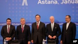 From left, Turkish Foreign Ministry Deputy Undersecretary Sedat Onal, Russia's special envoy on Syria Alexander Lavrentiev, Kazakh Foreign Minister Kairat Abdrakhmanov, UN Syria envoy Staffan de Mistura and Iran's Deputy Foreign Minister Hossein Jaber Ansari stand for a photo after the final statement following the talks on Syrian peace in Astana, Kazakhstan, Jan. 24, 2017. 