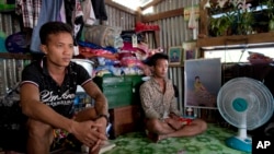 FILE - Former Burmese slave fishermen Kaung Htet Wai, left, and Lin Lin recently returned to Myanmar after being freed. Since 1932, an exemption in U.S. law allowed the import of goods produced by slaves and others forced into labor.