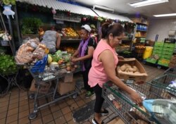 People on low-incomes and retirees choose food at the World Harvest Food Bank in Los Angeles on July 24, 2019.