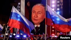 Vladimir Putin attends a rally marking the 10th anniversary of Russia's annexation of Crimea from Ukraine in Moscow on March 18, 2024.