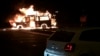 A van burns after an explosion near the regional administration building in Donetsk, eastern Ukraine, June 12, 2014.