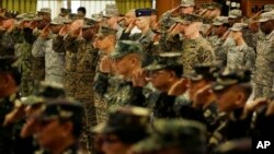 U.S. and Philippine troops salute during the opening ceremony of their joint military exercise dubbed "Balikatan 2015" at Camp Aguinaldo at suburban Quezon city, northeast of Manila, Philippines, April 20, 2015.