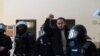Spanish rapper Pablo Hasel reacts as he is detained by riot police inside the University of Lleida, after he was sentenced to jail time on charges including insulting the monarchy and glorifying terrorism, in Lleida, Spain, Feb. 16, 2021. 