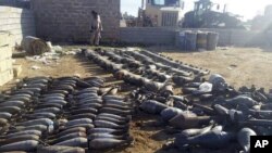 Weapons and explosives confiscated by Iraqi security forces from Islamic State militants are on display Dec. 22, 2015, at an Iraqi army base as security forces advance their position in northern Ramadi, west of Baghdad, Iraq. 