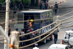 FILE - Police detain protesters as they crack down on demonstrations against the military coup in Yangon, Myanmar, Feb. 27, 2021.