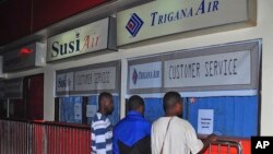 Relatives of passengers on the missing Trigana Air Service flight stand in front of its closed offices at Sentani airport in Jayapura, Papua province, Indonesia, Aug. 16, 2015.