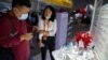 A visitor wearing a face mask looks at a model of a coronavirus and boxes for COVID-19 vaccines at a display by Chinese pharmaceutical firm Sinopharm at the China International Fair for Trade in Services (CIFTIS) in Beijing, Saturday, Sept. 5, 2020…