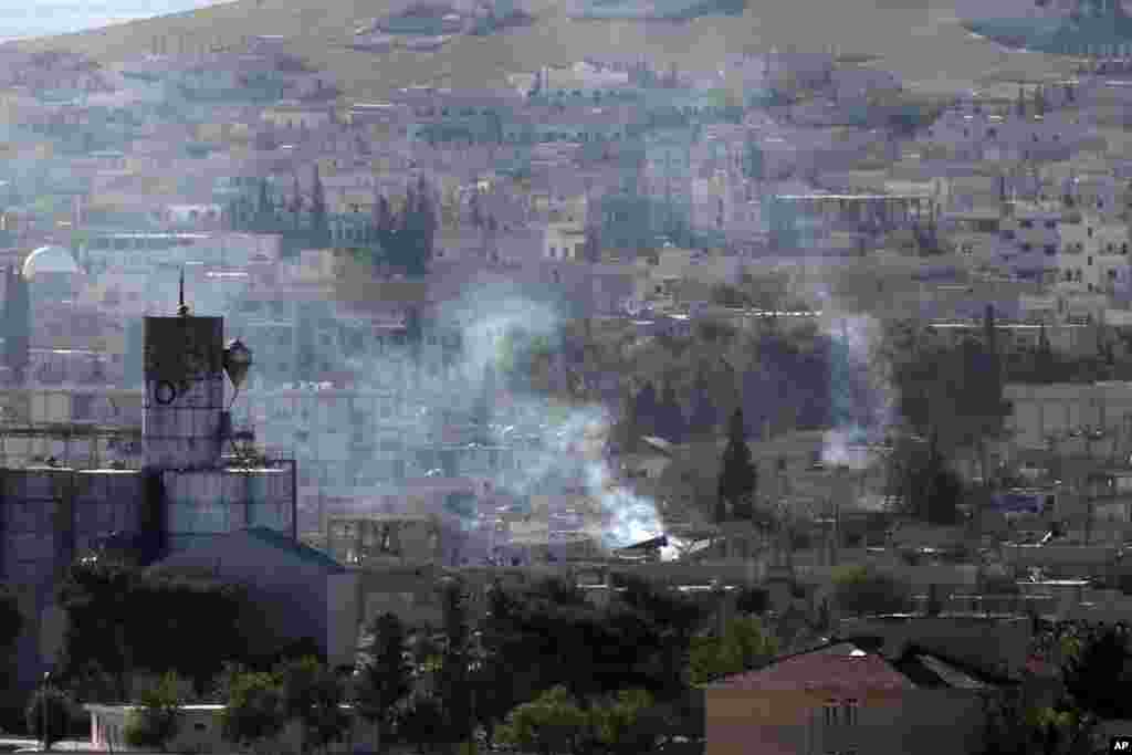 Smoke follows a strike during fighting between Syrian Kurds and the Islamic State militants, as seen from the Turkey-Syria border, Oct. 21, 2014.