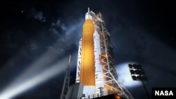 This illustration shows NASA’s new rocket, the Space Launch System (SLS), in its Block 1 crew vehicle setup that will send astronauts to the Moon on the Artemis missions. (Image Credit: NASA)