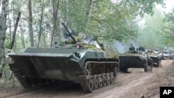 In this photo taken on Friday, Sept. 15, 2017, Belarusian army vehicles drive during the war games at an undisclosed location in Belarus. Russia and Belarus began major war games Thursday, an operation involving thousands of troops, tanks and aircraft on NATO's eastern edge.
