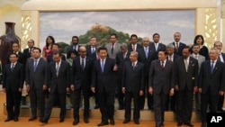 Chinese President Xi Jinping, center, shows the way to the guests who attended the signing ceremony of the Asian Infrastructure Investment Bank at the Great Hall of the People in Beijing, Oct. 24, 2014.