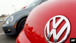 FILE - The Volkswagen logo is seen on the hood of a 2012 Beetle at a Volkswagen dealership.