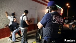 FILE - Federal agents with the U.S. Immigration and Customs Enforcement's (ICE) Homeland Security Investigations (HSI) detain a man in this handout picture taken in Dallas, Texas, March 30, 2014, and released May 1, 2014.