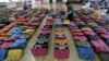 A police official checks some 400 counterfeit bags at the Jungbu police station in Seoul, South Korea, June 1, 2016. 