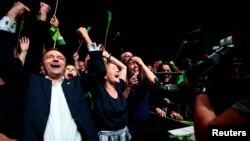 Leader of environmental MDG party Une Bastholm (right) and Arild Hermstad (left) cheer over the proviosional figures of local elections, in Oslo, Norway, Sept. 9, 2019.