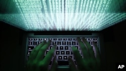 FILE - Two Iranians have been charged in an alleged scheme to steal and resell software to Iran.