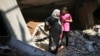 Palestinians look at their destroyed house as they return to it during a 72-hour truce in Beit Hanoun town, which witnesses said was heavily hit by Israeli shelling and air strikes during the Israeli offensive, in the northern Gaza Strip Aug. 11, 2014.