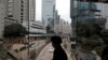 FILE - A woman walks on a bridge near the Central district of Hong Kong, Wednesday, Feb. 24, 2016. More than 10,000 people wrote to TVB to complain about the subtitles.