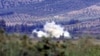 Smoke rises after a mortar bomb fired from Syria landed on Turkish soil on the Turkish-Syrian border in southern Hatay province, October 8, 2012.