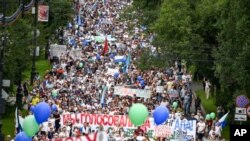 People hold posters supporting Khabarovsk region's governor Sergei Furgal, during an unsanctioned protest in support of Sergei Furgal, who was interrogated and ordered to be held in jail for two months, in Khabarovsk, Russia, July 25, 2020.