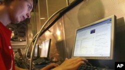 FILE - A customer uses a computer at an Internet cafe in downtown Moscow, July 6, 2006