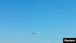 FILE - An unidentified plane flies near disputed islands, called Senkaku in Japan and Diaoyu in China, in the air over the East China Sea, in this handout photo taken by Japan Air Self-Defence Force and released by Joint Staff of the Defence Ministry of J