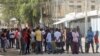 FILE - Somalis gather on a street during fighting between Somali government forces and opposition troops over delayed elections in Mogadishu, Somalia, Feb. 19, 2021. 