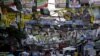 Election posters for the 2016 national elections hang above a busy road in Tondo, Manila, April 26, 2016. 