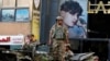 FILE - Lebanese army soldiers on their armored vehicle stand guard in Beirut, Oct. 15, 2021, at the site where deadly clashes erupted the previous day.